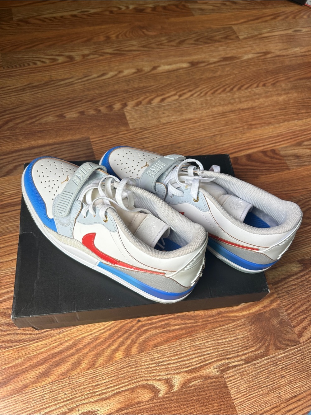 Nike Kids White Sneakers with Blue Accents and Red Swoosh